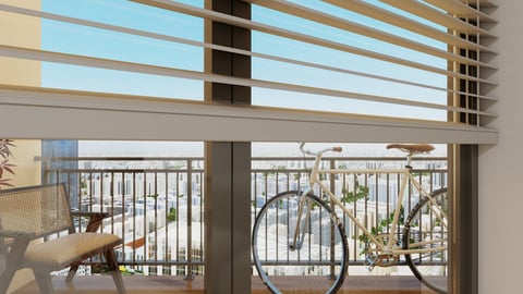 Modern balcony with metal railings, bicycle, potted plants, and view of blue sky through horizontal window blinds